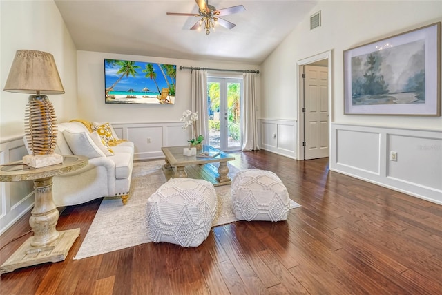 sitting room with a ceiling fan, visible vents, vaulted ceiling, a decorative wall, and hardwood / wood-style floors