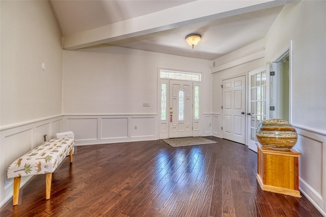 entryway featuring wainscoting, a decorative wall, and dark wood-style floors