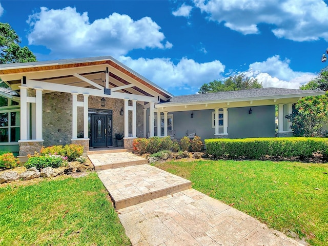 898 Cypress Lakeview Ct, Tarpon Springs, FL 34688 - view of front of house featuring a front yard, stucco siding, a porch, and stone siding
