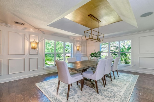 898 Cypress Lakeview Ct, Tarpon Springs, FL 34688 - dining space with a chandelier, a decorative wall, plenty of natural light, a tray ceiling, and baseboards