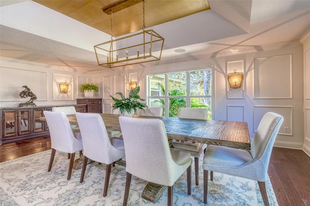 898 Cypress Lakeview Ct, Tarpon Springs, FL 34688 - dining room with a decorative wall, a chandelier, and dark wood-style floors