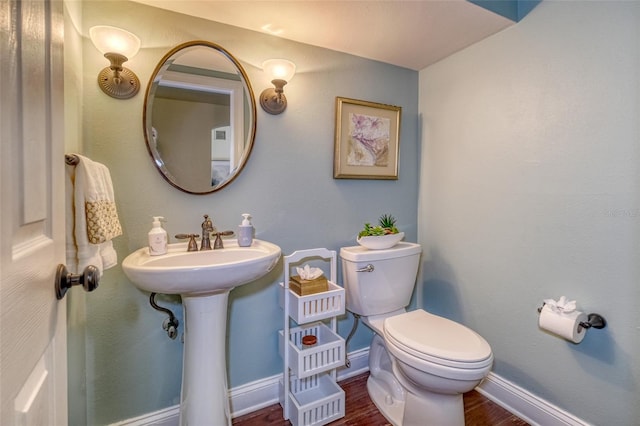 898 Cypress Lakeview Ct, Tarpon Springs, FL 34688 - bathroom with toilet, wood finished floors, and baseboards