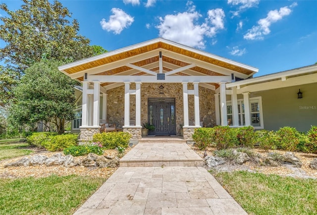 898 Cypress Lakeview Ct, Tarpon Springs, FL 34688 - property entrance with stone siding and a porch