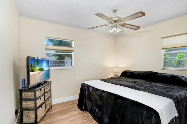 3214 W Rogers Ave, Tampa, FL 33611 - bedroom featuring light wood finished floors, baseboards, and a ceiling fan