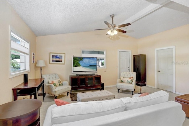 3214 W Rogers Ave, Tampa, FL 33611 - living room with vaulted ceiling, a ceiling fan, baseboards, and a textured ceiling