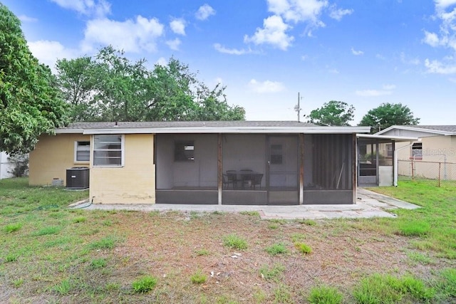 3214 W Rogers Ave, Tampa, FL 33611 - rear view of property featuring a sunroom, central air condition unit, and concrete block siding