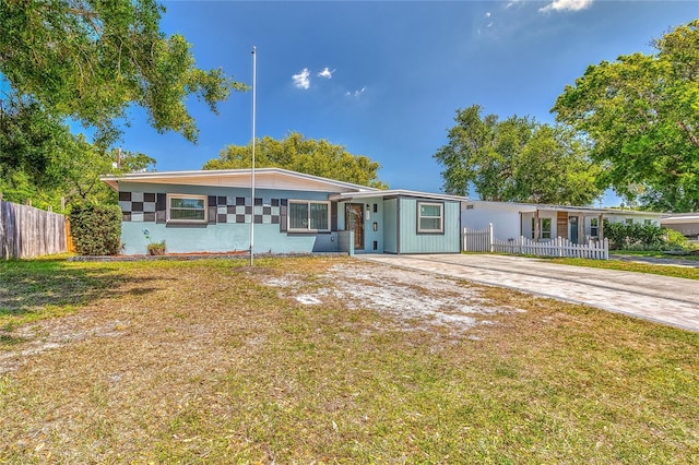 3045 Stratford Dr, Largo, FL 33771 - view of front of house featuring driveway, a front lawn, and fence