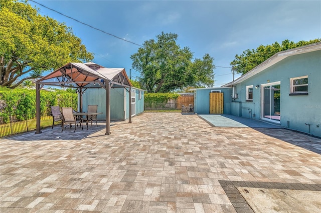 3045 Stratford Dr, Largo, FL 33771 - view of patio featuring a gazebo, outdoor dining area, a fenced backyard, and an outdoor structure