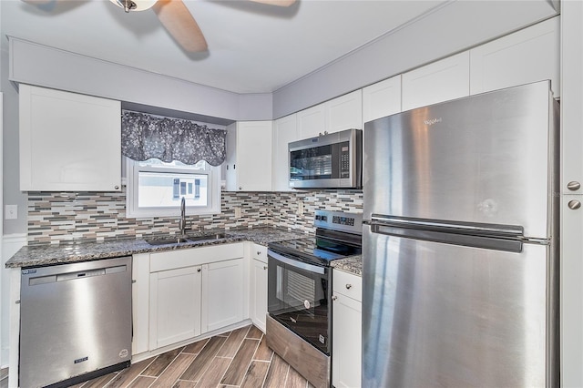 3045 Stratford Dr, Largo, FL 33771 - kitchen featuring white cabinets, appliances with stainless steel finishes, tasteful backsplash, and a sink