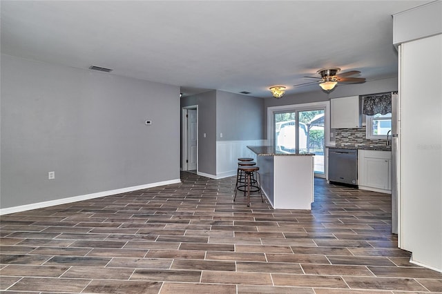 3045 Stratford Dr, Largo, FL 33771 - kitchen with a kitchen breakfast bar, dishwasher, visible vents, white cabinetry, and ceiling fan
