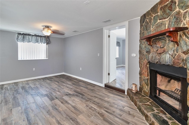 3045 Stratford Dr, Largo, FL 33771 - unfurnished living room featuring ceiling fan, dark wood-style floors, visible vents, and a fireplace
