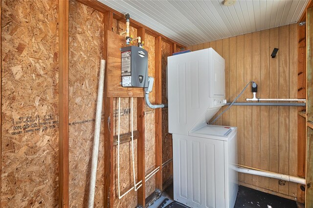 3045 Stratford Dr, Largo, FL 33771 - washroom featuring water heater, wooden walls, stacked washing maching and dryer, and laundry area
