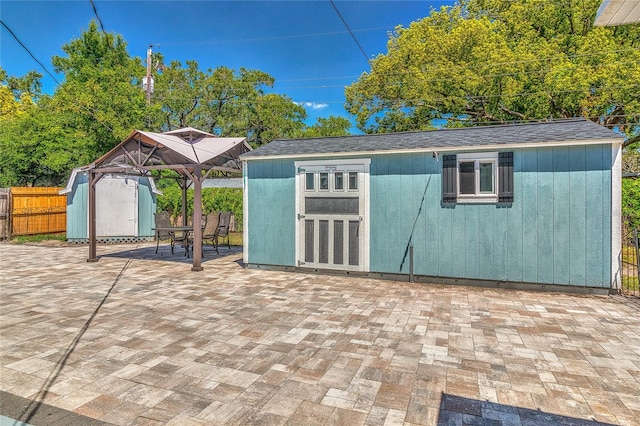 3045 Stratford Dr, Largo, FL 33771 - view of shed featuring a gazebo, outdoor dining area, and a fenced backyard
