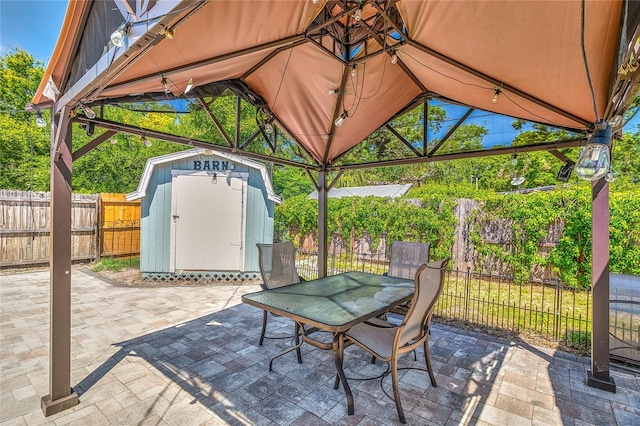 3045 Stratford Dr, Largo, FL 33771 - view of patio with a fenced backyard, outdoor dining space, a shed, an outdoor structure, and a gazebo