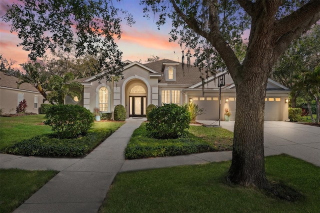 15930 Sorawater Dr, Lithia, FL 33547 - view of front of home featuring driveway, stucco siding, an attached garage, and a front yard