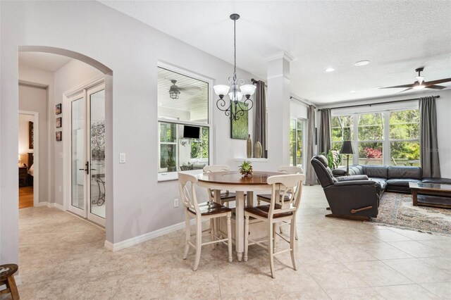 15930 Sorawater Dr, Lithia, FL 33547 - dining area with arched walkways, a ceiling fan, recessed lighting, light tile patterned floors, and a chandelier