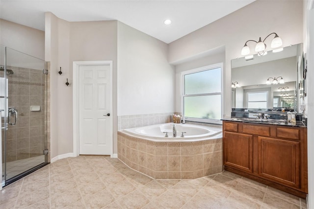 15930 Sorawater Dr, Lithia, FL 33547 - bathroom featuring vanity, a bath, a stall shower, and tile patterned flooring