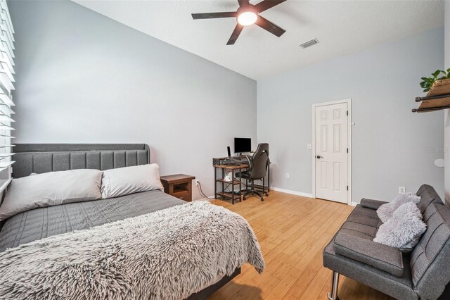 15930 Sorawater Dr, Lithia, FL 33547 - bedroom with light wood-type flooring, a ceiling fan, an office area, baseboards, and high vaulted ceiling