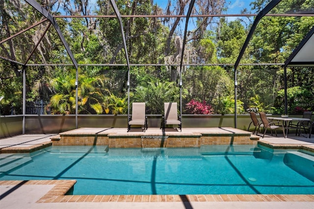 15930 Sorawater Dr, Lithia, FL 33547 - swimming pool featuring a patio, a lanai, and view of wooded area