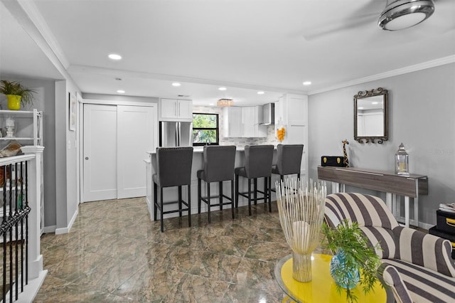 105 4th Ave NE Unit 219, Saint Petersburg, FL 33701 - interior space featuring freestanding refrigerator, a peninsula, white cabinets, and wall chimney range hood