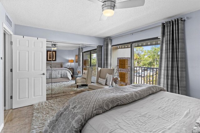 105 4th Ave NE Unit 219, Saint Petersburg, FL 33701 - bedroom with access to outside, a textured ceiling, a ceiling fan, visible vents, and a closet