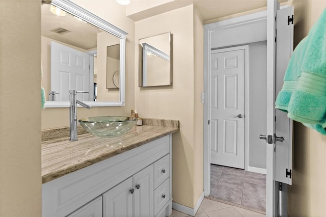 105 4th Ave NE Unit 219, Saint Petersburg, FL 33701 - bathroom with vanity, tile patterned flooring, baseboards, and visible vents