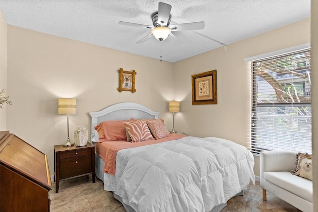 105 4th Ave NE Unit 219, Saint Petersburg, FL 33701 - bedroom featuring a ceiling fan, a textured ceiling, and light tile patterned floors