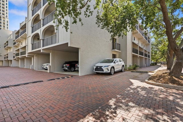 105 4th Ave NE Unit 219, Saint Petersburg, FL 33701 - view of building exterior with covered and uncovered parking