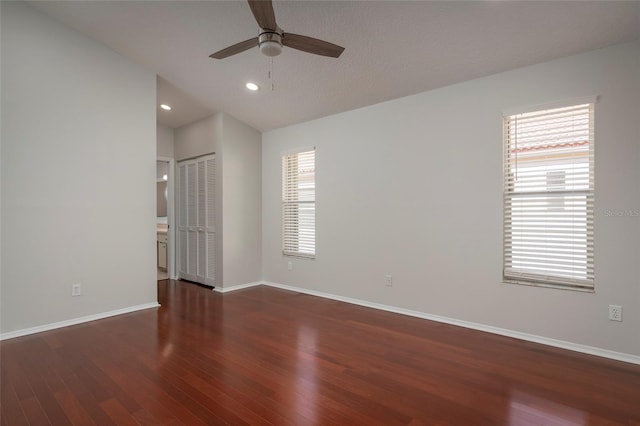 empty room with baseboards, ceiling fan, recessed lighting, wood finished floors, and lofted ceiling