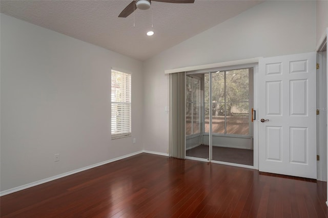unfurnished room featuring hardwood / wood-style floors, a ceiling fan, lofted ceiling, and plenty of natural light