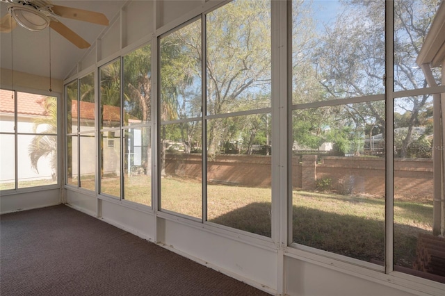 unfurnished sunroom featuring ceiling fan