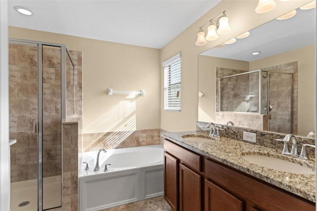 full bathroom with a bath, a stall shower, double vanity, and a sink