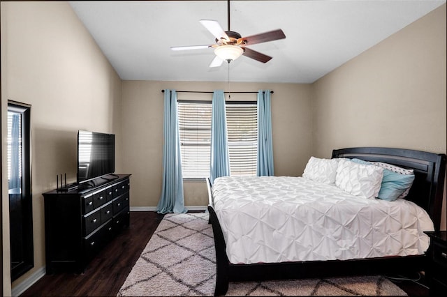 bedroom featuring dark wood-type flooring, baseboards, and ceiling fan