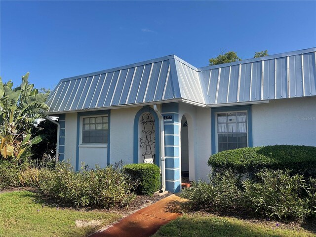 4237 Tamargo Dr Unit 4237, New Port Richey, FL 34652 - exterior space featuring stucco siding, mansard roof, metal roof, and a standing seam roof