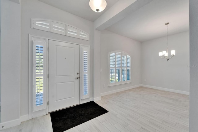 5419 Knights Landing Dr, Lakeland, FL 33810 - entryway with baseboards, a notable chandelier, wood finished floors, and a healthy amount of sunlight