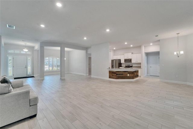5419 Knights Landing Dr, Lakeland, FL 33810 - living area featuring recessed lighting, light wood-type flooring, visible vents, and baseboards