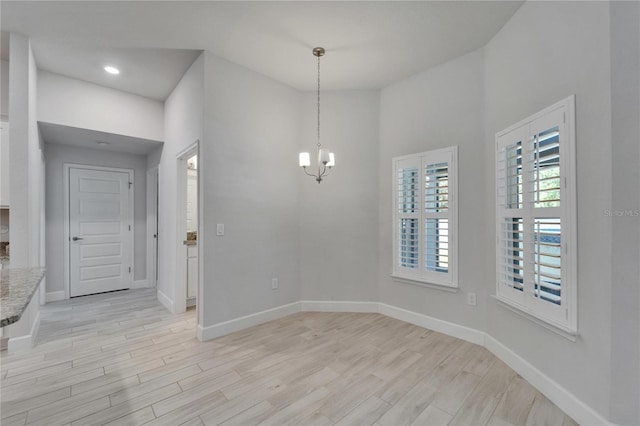 5419 Knights Landing Dr, Lakeland, FL 33810 - unfurnished dining area featuring light wood-style flooring, recessed lighting, a notable chandelier, and baseboards