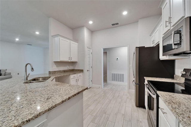 5419 Knights Landing Dr, Lakeland, FL 33810 - kitchen featuring a sink, visible vents, light stone countertops, and stainless steel appliances