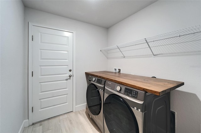 5419 Knights Landing Dr, Lakeland, FL 33810 - laundry area featuring washer and dryer, light wood-style floors, laundry area, and baseboards