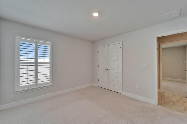 5419 Knights Landing Dr, Lakeland, FL 33810 - unfurnished bedroom featuring a closet, baseboards, visible vents, and carpet floors