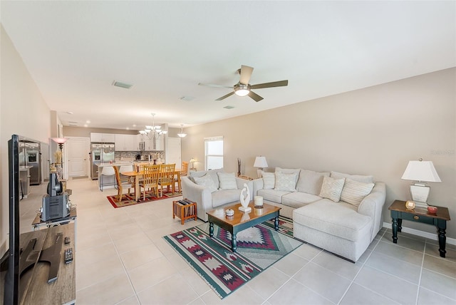 6333 Milestone Loop, Palmetto, FL 34221 - living area featuring ceiling fan with notable chandelier, baseboards, visible vents, and light tile patterned flooring