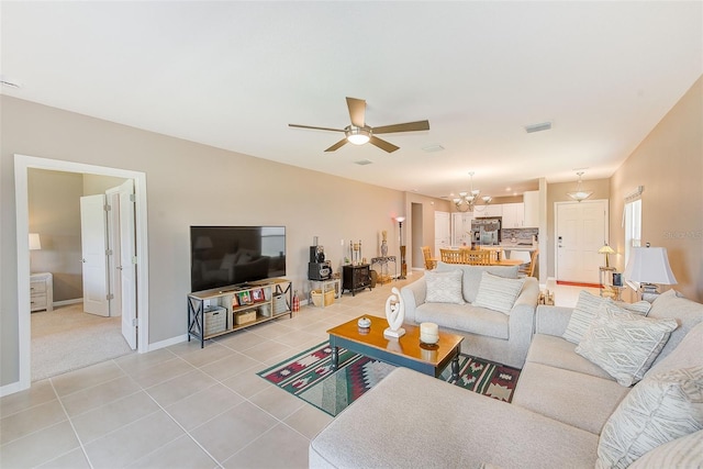 6333 Milestone Loop, Palmetto, FL 34221 - living room with ceiling fan with notable chandelier, visible vents, baseboards, and light tile patterned floors