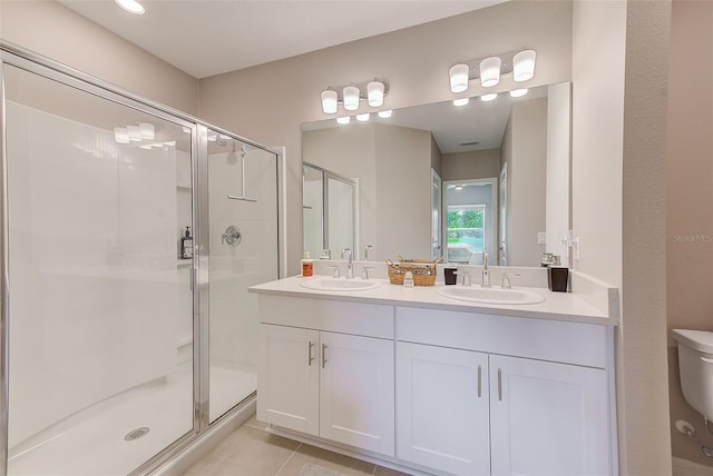 6333 Milestone Loop, Palmetto, FL 34221 - bathroom featuring a sink, a shower stall, double vanity, and toilet