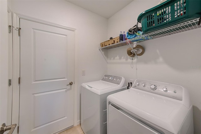 6333 Milestone Loop, Palmetto, FL 34221 - laundry area with washing machine and clothes dryer, light tile patterned flooring, and laundry area
