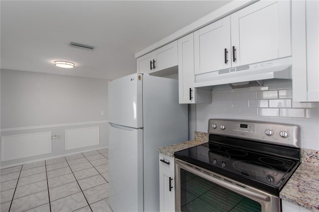 kitchen featuring white cabinetry, freestanding refrigerator, under cabinet range hood, visible vents, and electric stove
