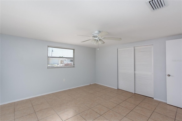unfurnished bedroom with visible vents, ceiling fan, a closet, and baseboards