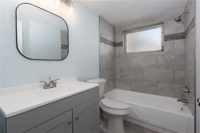 bathroom with toilet, shower / bathing tub combination, and vanity