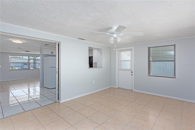 unfurnished room with light tile patterned floors, visible vents, a ceiling fan, a textured ceiling, and crown molding