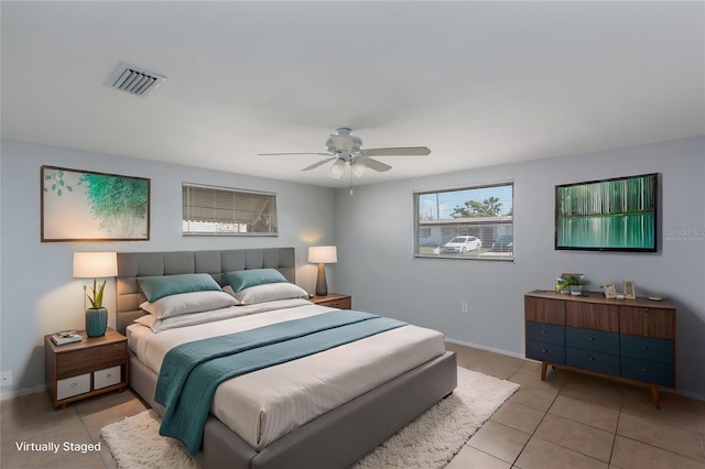 bedroom featuring light tile patterned floors, baseboards, a ceiling fan, and visible vents