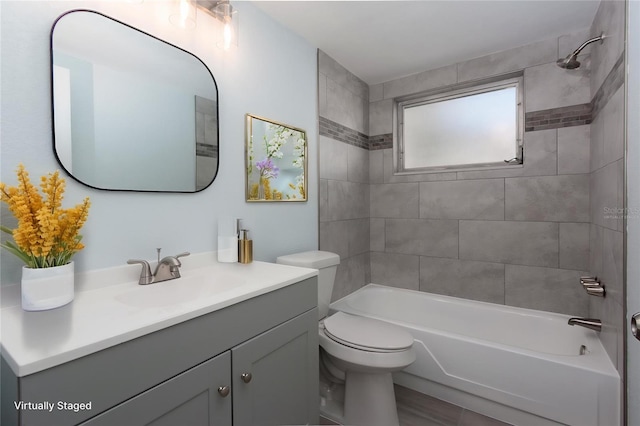 full bath with toilet, vanity, and shower / washtub combination